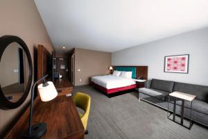 a hotel room with a bed and a couch at Hampton Inn Needles Colorado River in Needles