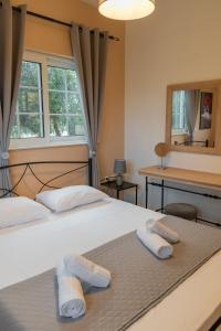 a bedroom with a bed with two towels on it at Monte Mare Rhodes in Ixia