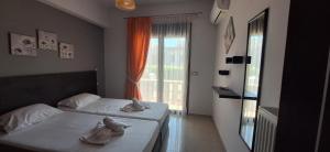 a bedroom with two beds and a window at Rhodian Villa in Kremasti +23 photos