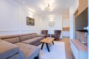 a living room with a couch and a table at Horizon Apartments in Prčanj