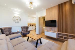 a living room with a couch and a tv at Horizon Apartments in Prčanj