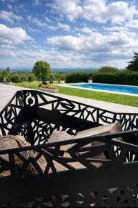 a wooden bench sitting in front of a fence at Casa refugio in Santa María +2 photos
