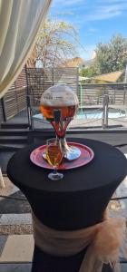 a woman holding a table with a wine glass on it at Villa Glamour in Utjeha
