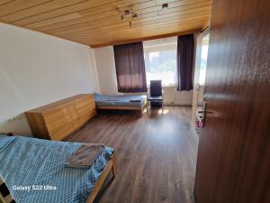a bedroom with two beds and a wooden ceiling at Zimmer zu vermieten in Rammingen