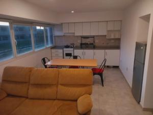 a living room with a couch and a table at Bernal Alquileres in Viedma
