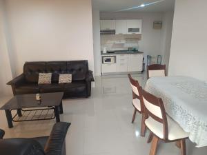 a living room with a bed and a table and chairs at Pattaya Center Point Condo in Pattaya