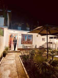 a woman standing in front of a house at night at Villa 2VB in Shkodër