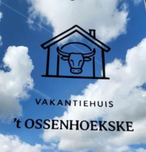 a sign with a cow in a house in the sky at 't Ossenhoekske in Sint-Niklaas