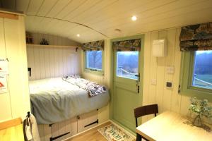 a room with a bed in a small room at Spinney Wood Glamping, Oak Hut in Bewdley