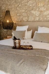 a tray with two wine glasses on a bed at Mas Escarrà in Caldes de Malavella
