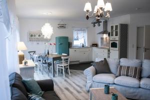 a living room and kitchen with a couch and a table at Ferienwohnung Viva la Vida in Bendorf