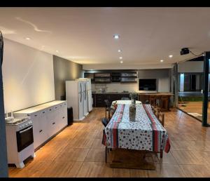 a kitchen with a table with a table cloth on it at Quinta "La Calma" in Puerto Iguazú