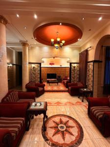 a large living room with couches and a fireplace at Fouad Hotel in Alexandria