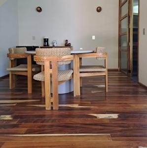 a dining room with a wooden table and chairs at Musa Hotel Boutique in Bucerías