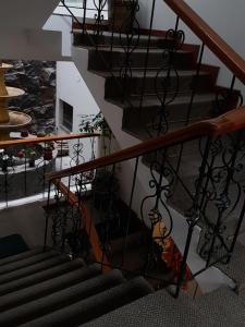a spiral staircase in a building with wrought iron railings at Cordelius Hotel in Puno