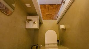 a small bathroom with a toilet and a mirror at Casa do Largo Ericeira in Ericeira +12 photos