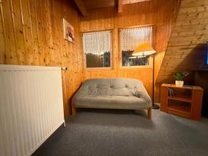 a room with a couch and a lamp and a window at RS Aparthotel in Schöppenstedt