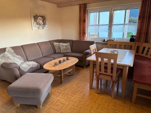 a living room with a couch and a table at Ferienhaus Heidi in Lam