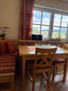 a dining room with a table and chairs and a window at Ferienhaus Heidi in Lam +11 photos