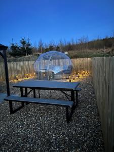 a picnic table with a glass dome on top of it at Maneight Retreat with Hot tub in New Cumnock +4 photos