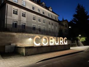 a building with a sign that reads colossus at Apartment am Bahnhof mit Self-Check-in in Coburg
