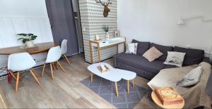 a living room with a couch and a table at Appartement T1 Superdévoluy 6 personnes in Le Dévoluy
