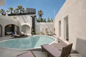 a swimming pool in the middle of a house at No908 Sunset HOTEL in Çeşme