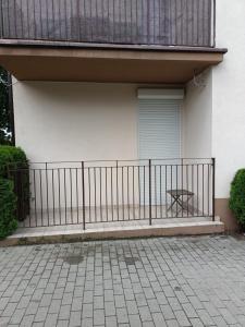 a fence in front of a house with a window at MoRze MielNo in Mielno +5 photos