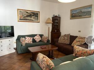 a living room with two couches and a table at Casa Nina in Marina di Massa