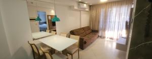 a living room with a table and a couch at Landscape Apartment TC1502 in Fortaleza