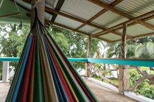 a colorful dress hanging from a roof at Guesthouse Island Escape in Corn Islands +22 photos