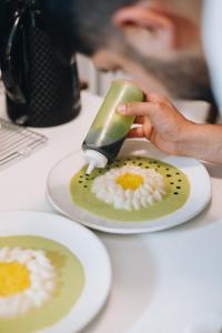 a person is scrubbing a plate of food on a table at Increible Chalet en La Parva in Santiago