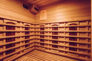 a sauna with wooden racks with ties in it at B&W Malina Jacuzzi Suite in Lelystad