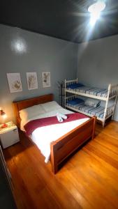 a bedroom with two bunk beds and a wooden floor at Hospedagem 154 Colonial in Gramado