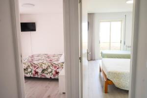a view of a bedroom with a bed and a window at Ofir Nature Stay in Fão +42 photos