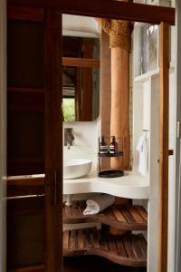 a bathroom with a sink and a mirror at Sohla Hotel Popoyo in Playa Santana