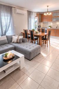 a living room with a couch and a table at Epanomi Family Apartments in Epanomi