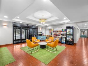 a waiting room at a store with chairs and a table at Spark By Hilton Ann Arbor South in Ann Arbor