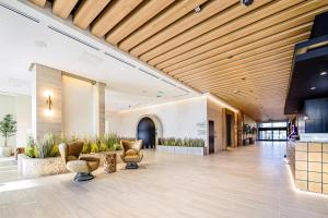 a lobby with chairs and plants in a building at The Key Hotel Dubuque, Tapestry Collection By Hilton in Dubuque