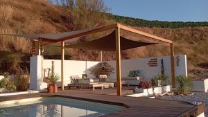 a patio with a canopy and a pool at Casa Gaïa in Borge +17 photos