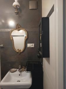 a bathroom with a sink and a mirror on the wall at Chata za Wsią u Kowalików in Skała