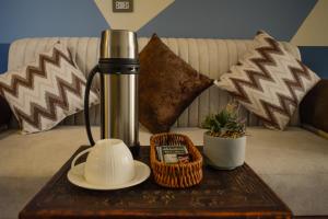 a coffee table with a thermos on top of a couch at Andari Hoteles in Arequipa