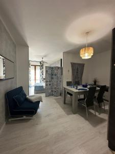 a living room with a dining room table and chairs at La Terrazza sul Delta in Porto Levante