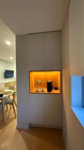 a kitchen with a counter with a light in it at Apartamento de Real in Braga