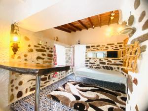 a room with a counter and a table and a rug at BadeHan Guest House in Çeşme