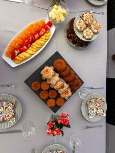 a table topped with plates of food and snacks at Hotel Areias Claras in Viana do Castelo