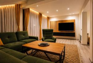 a living room with a couch and a table at Danin's Home in Tuzla