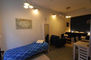 a bedroom with a bed and a living room at Izba Kupiecka in Bystrzyca Kłodzka