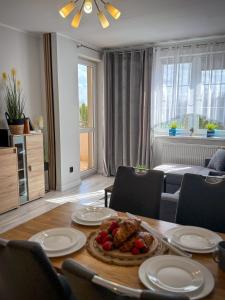 a living room with a table with food on it at Apartament Lake Piastowska in Ostróda