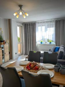 a living room with a table with food on it at Apartament Lake Piastowska in Ostróda +21 photos